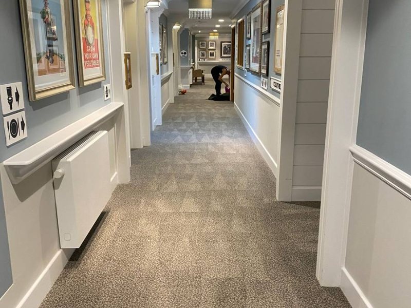 Communal corridor, carpet cleaned the full length, working around residents
