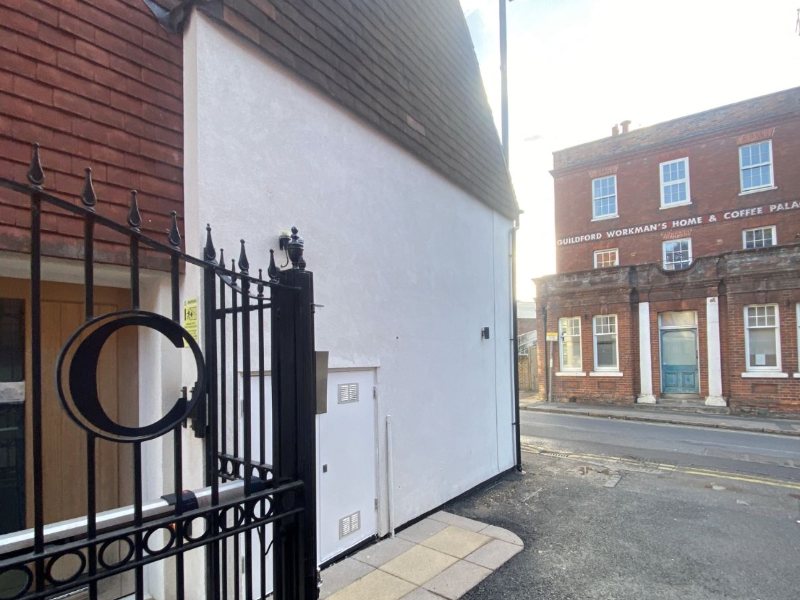 Gated street entrance, render and paving cleaned back to white