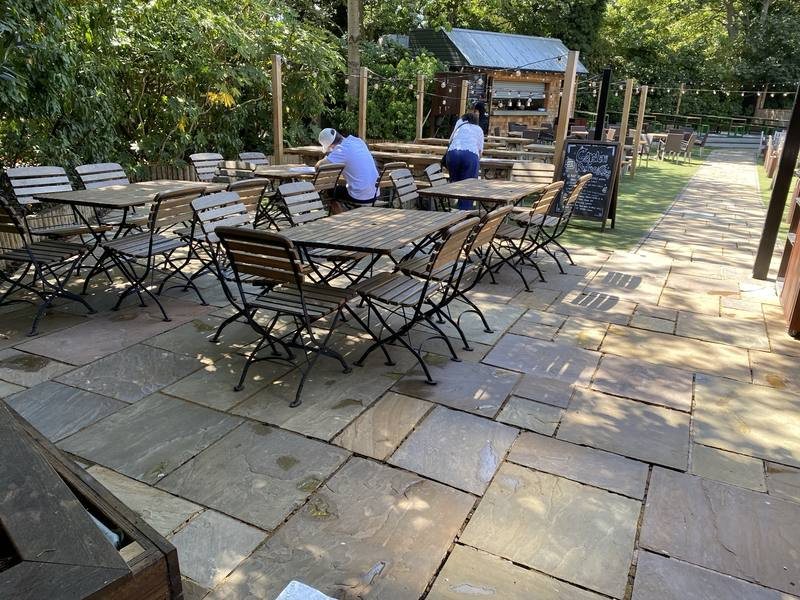 Rear seating area, sandstone paving cleaned